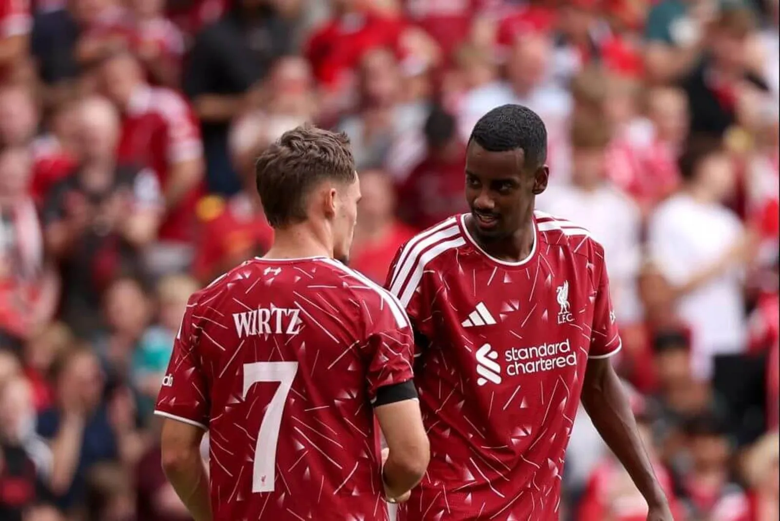 Alexander Isak and Florian Wirtz celebrate during Liverpool's pre-season game against Monaco at Anfield on Sunday