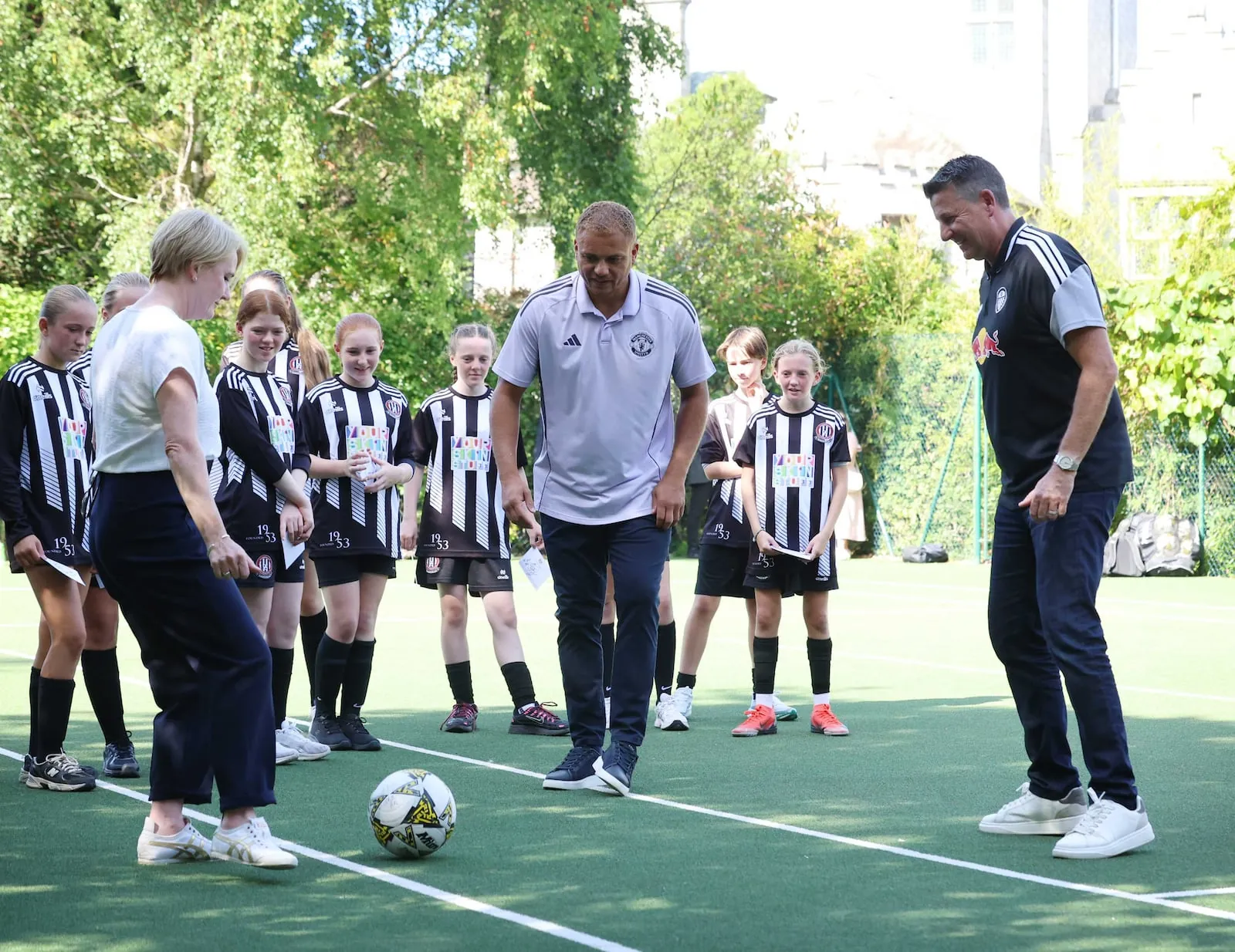 Manchester United legend Wes Brown and former Leeds United striker Michael Bridges with British ambassador Kara Owen as young players from St Joseph's AFC look on. Photograph: Leon Farrell/Photocall
